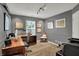 Cozy home office with elegant wainscoting, decorative lighting, and a large window for natural light at 15890 Concert Way, Noblesville, IN 46060