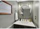 Stylish powder room featuring modern vanity, a round mirror, and elegant lighting fixtures at 15890 Concert Way, Noblesville, IN 46060
