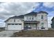 Exterior of a two-story home with a white garage door and covered porch in the construction phase at 16453 Alps Rd, Noblesville, IN 46060