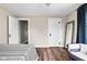Bedroom featuring hardwood floors, large windows with curtains, and a cozy seating area at 1646 Fisher Ave, Indianapolis, IN 46224