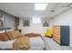 This is a view of the staged bedroom, featuring a bed and an adjacent yellow chair at 1646 Fisher Ave, Indianapolis, IN 46224