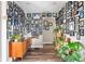 Hallway adorned with a curated gallery wall, hardwood floors, plants, and natural light at 1646 Fisher Ave, Indianapolis, IN 46224