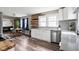 Bright eat-in kitchen featuring modern white cabinets, gray countertops, and natural wood plank accent wall at 1646 Fisher Ave, Indianapolis, IN 46224