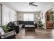 Inviting living room features hardwood floors, a ceiling fan, and a comfortable, large sectional sofa at 1646 Fisher Ave, Indianapolis, IN 46224