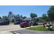 Lively neighborhood scene with houses, cars, and people enjoying a sunny day at 1646 Fisher Ave, Indianapolis, IN 46224