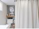 Here is a view of the toilet area of the bathroom, showcasing a shelf with decor at 1646 Fisher Ave, Indianapolis, IN 46224