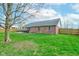 Large backyard with grassy lawn and a brick house at 1707 Lafayette Ave, Lebanon, IN 46052