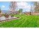 Backyard with a patio, dining set, playhouse, shed, and well-maintained grass at 1707 Lafayette Ave, Lebanon, IN 46052