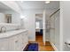 Bright bathroom featuring a marble countertop double vanity and a glass-door shower at 1707 Lafayette Ave, Lebanon, IN 46052
