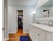 Stylish bathroom with a double sink vanity, marble countertops, and an adjacent walk-in closet for ample storage at 1707 Lafayette Ave, Lebanon, IN 46052