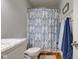 Bathroom features a blue and white patterned shower curtain and wood floors at 1707 Lafayette Ave, Lebanon, IN 46052