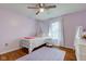 bedroom with lavender walls, ceiling fan, and a whimsical unicorn theme at 1707 Lafayette Ave, Lebanon, IN 46052