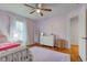 bedroom with lavender walls, ceiling fan, and a white dresser at 1707 Lafayette Ave, Lebanon, IN 46052
