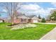 Charming brick home with a well-manicured lawn, mature trees, and an attached two-car garage at 1707 Lafayette Ave, Lebanon, IN 46052