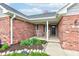 Charming front porch with rocking chairs and well-maintained landscaping at brick home at 1707 Lafayette Ave, Lebanon, IN 46052
