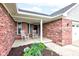 Charming front porch with rocking chairs, landscaping, and brick exterior at 1707 Lafayette Ave, Lebanon, IN 46052