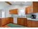 Well-equipped kitchen featuring granite countertops, stainless steel appliances, and wood cabinets at 1707 Lafayette Ave, Lebanon, IN 46052