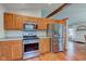 View of a modern kitchen with stainless steel appliances and wooden cabinets, seamlessly blending style and functionality at 1707 Lafayette Ave, Lebanon, IN 46052