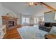 Cozy living room featuring a brick fireplace, hardwood floors, and exposed beam ceiling at 1707 Lafayette Ave, Lebanon, IN 46052