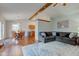 Open-concept living room featuring an area rug, hardwood floors, and a comfortable sectional sofa at 1707 Lafayette Ave, Lebanon, IN 46052