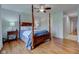 Spacious main bedroom with hardwood floors, complemented by a ceiling fan and elegant, comfortable furniture at 1707 Lafayette Ave, Lebanon, IN 46052