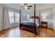 Well-lit main bedroom featuring hardwood floors, ceiling fan and a large window creating a serene space at 1707 Lafayette Ave, Lebanon, IN 46052