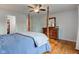Comfortable bedroom boasting hardwood floors, a ceiling fan, and a classic dresser, offering a relaxing retreat at 1707 Lafayette Ave, Lebanon, IN 46052