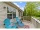 Back deck featuring two chairs and a small table with a view of manicured yard at 17777 Crown Pointe Ct, Noblesville, IN 46062