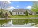 A beautiful view of the backyard with a pond and a deck with outdoor furniture at 17777 Crown Pointe Ct, Noblesville, IN 46062