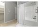 Clean bathroom featuring a shower-tub combo and walk-in closet access at 17777 Crown Pointe Ct, Noblesville, IN 46062