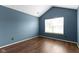 The bedroom features wood flooring, blue walls, and a window for ample natural light at 17777 Crown Pointe Ct, Noblesville, IN 46062