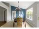 Charming dining room featuring modern lighting fixture, large window, and views of the backyard at 17777 Crown Pointe Ct, Noblesville, IN 46062