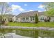 Exterior view of home showing pond, backyard, and deck with chairs at 17777 Crown Pointe Ct, Noblesville, IN 46062