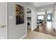 Hallway with a laundry area with modern appliances visible, leading into the living areas at 17777 Crown Pointe Ct, Noblesville, IN 46062