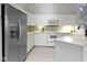 Well-lit kitchen featuring white cabinetry, modern appliances, and tile flooring at 17777 Crown Pointe Ct, Noblesville, IN 46062