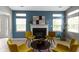 Cozy living room with fireplace, stylish decor, and natural light from the windows at 17777 Crown Pointe Ct, Noblesville, IN 46062