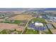 A charming lot is seen in an aerial view near a church, school, and open fields at 1911 N Rangeline Rd, Anderson, IN 46012