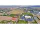 A charming lot is surrounded by an approximate property line in an aerial view near a church and open fields at 1911 N Rangeline Rd, Anderson, IN 46012