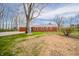 The home's brick back exterior features multiple windows and a spacious backyard at 1911 N Rangeline Rd, Anderson, IN 46012