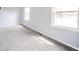 An empty bedroom offers neutral walls, gray carpet, and natural light from the double windows at 1911 N Rangeline Rd, Anderson, IN 46012