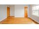 The neutral bedroom offers hardwood floors, two closets, and a double window at 1911 N Rangeline Rd, Anderson, IN 46012