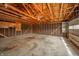 Unfinished garage interior showing the wooden framework and concrete floor, ready for customization at 1911 N Rangeline Rd, Anderson, IN 46012
