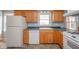 Well-lit kitchen featuring wood cabinets, ample counter space, and modern appliances at 1911 N Rangeline Rd, Anderson, IN 46012