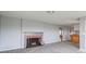 Spacious living room with a charming fireplace, carpeted floors, and neutral decor at 1911 N Rangeline Rd, Anderson, IN 46012