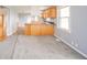 A bright and open living room with gray walls, wood flooring, and an open concept kitchen at 1911 N Rangeline Rd, Anderson, IN 46012