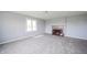 Bright living room with a brick fireplace, carpeted floors, and neutral color palette at 1911 N Rangeline Rd, Anderson, IN 46012