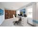 Bright office space features a built-in bookshelf and a white desk with modern computer setup at 1911 N Rangeline Rd, Anderson, IN 46012