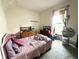 This bedroom has a bed and several dressers, plus a window to let in natural light at 2208 Avondale Pl, Indianapolis, IN 46218