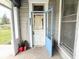 View of a front porch showing the address of the house and an open door at 2208 Avondale Pl, Indianapolis, IN 46218
