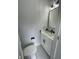 Modern bathroom features a stylish black faucet, sleek mirror, and a white vanity with a marble countertop at 2232 Central Ave, Indianapolis, IN 46205